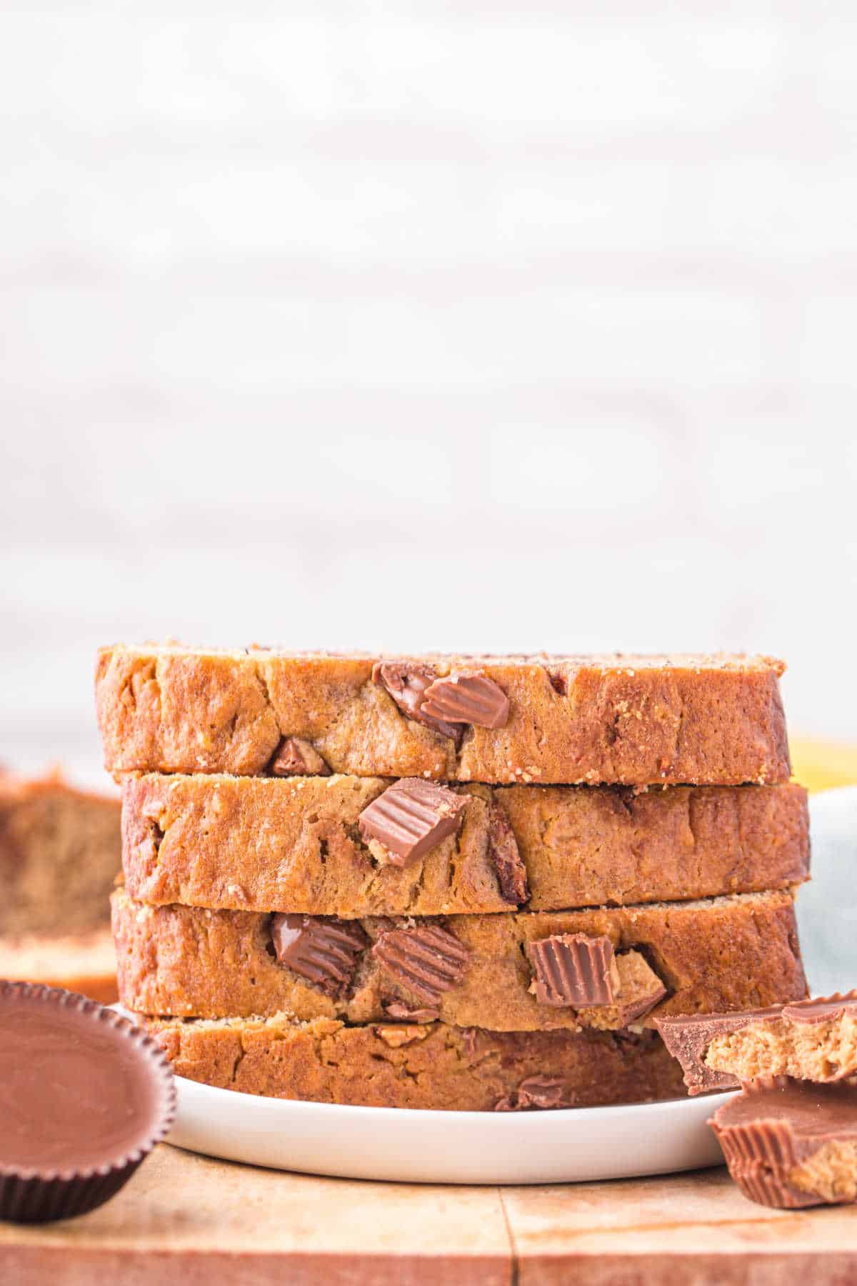 A stack of Reese's peanut butter banana bread slices on a plate.