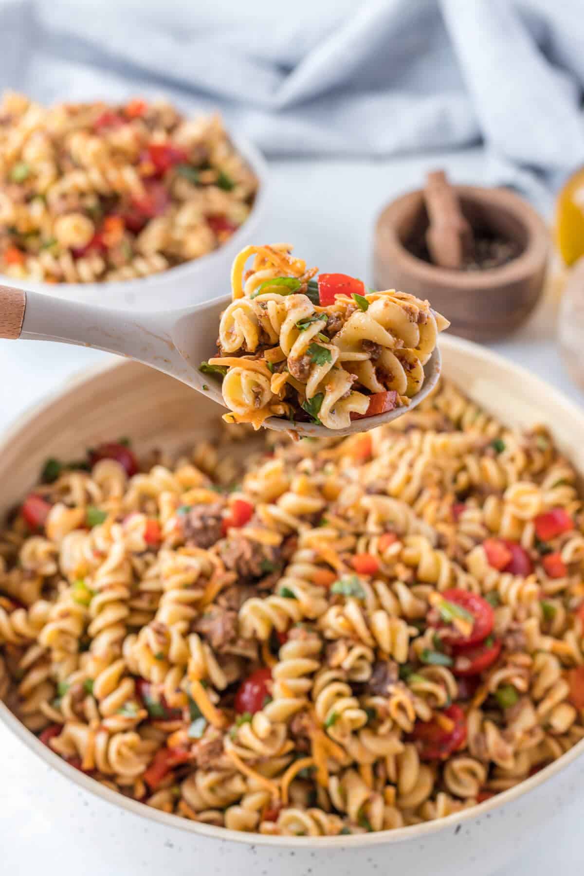 A serving spoon with taco pasta salad.
