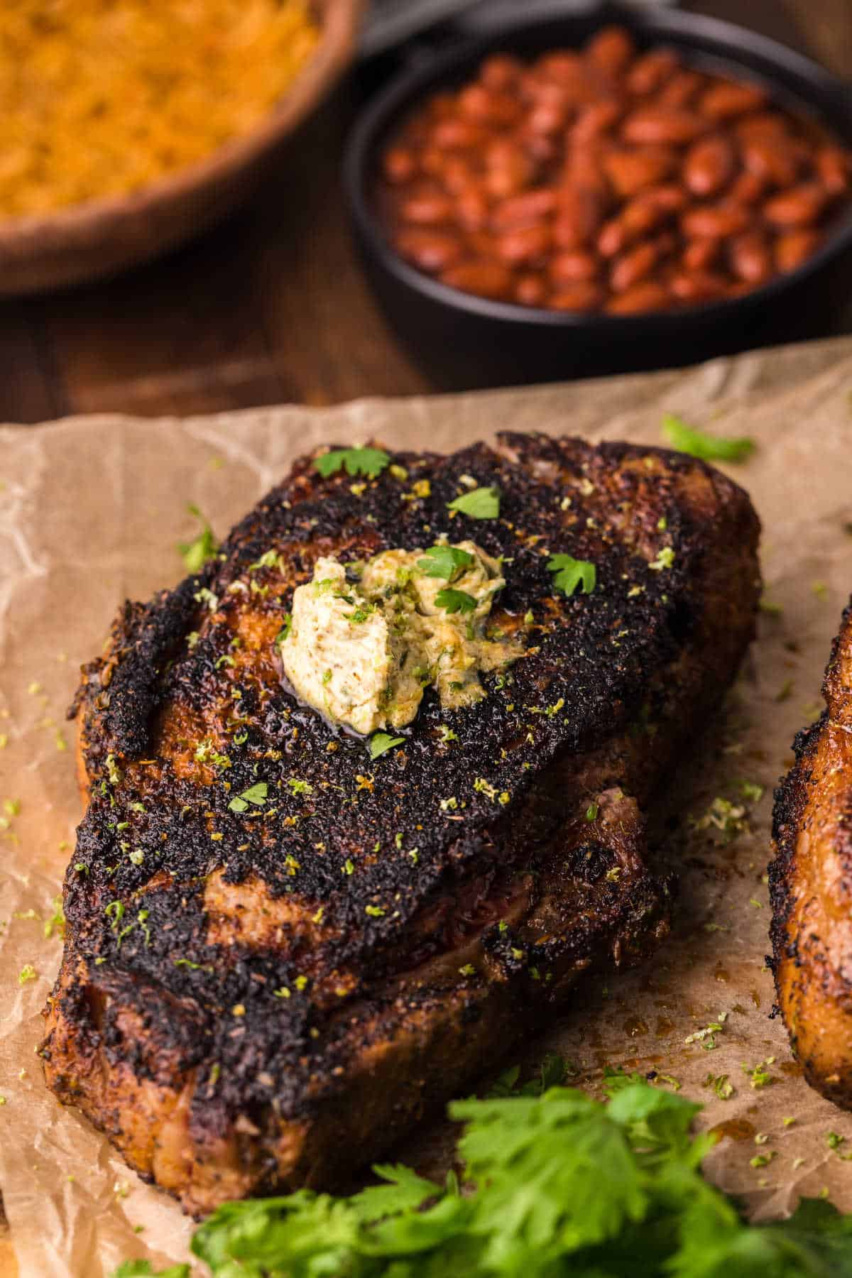 Blackened steak on a piece of parchment paper.