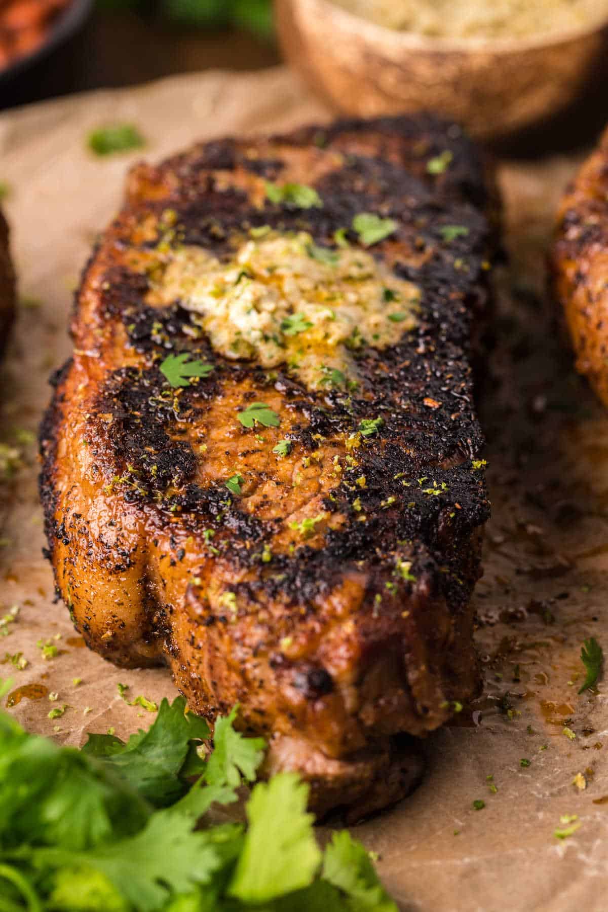 Blackened steak on a piece of parchment paper.