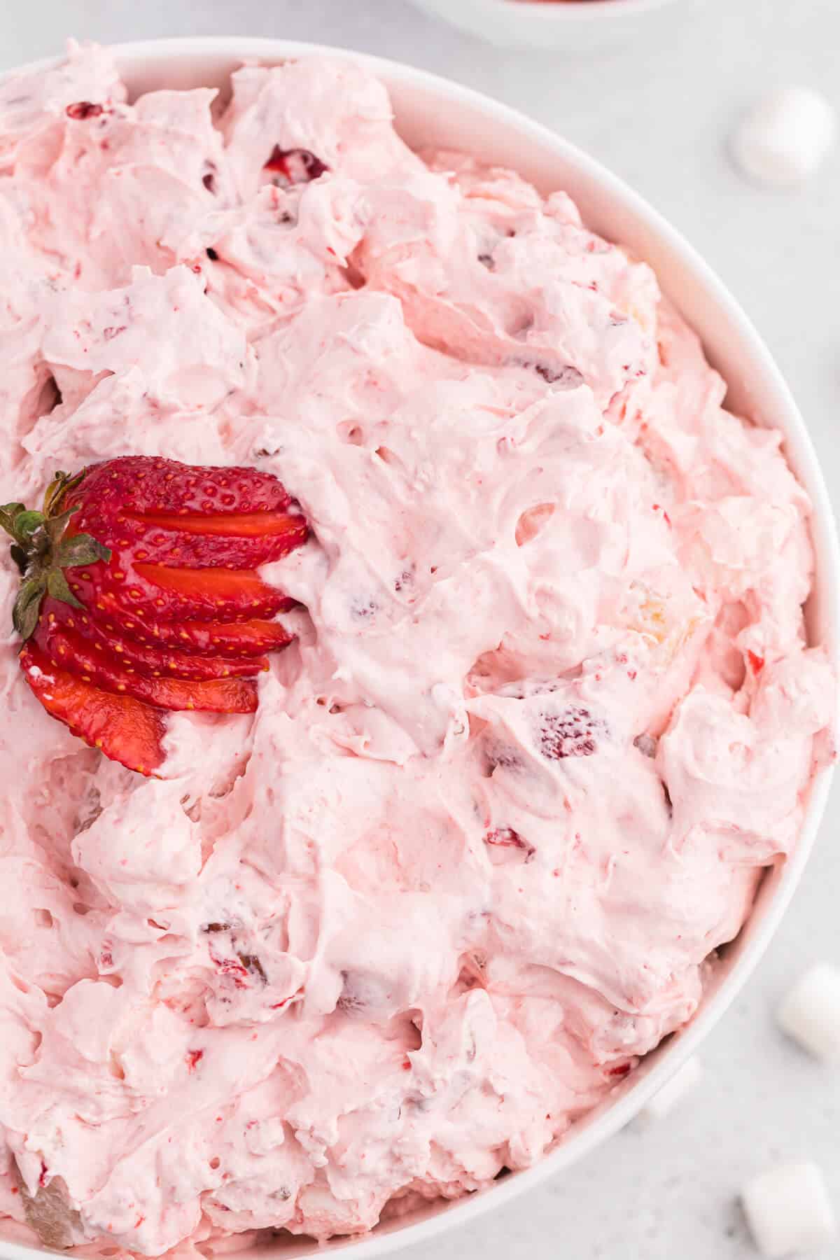 Strawberry fluff salad in a white bowl.
