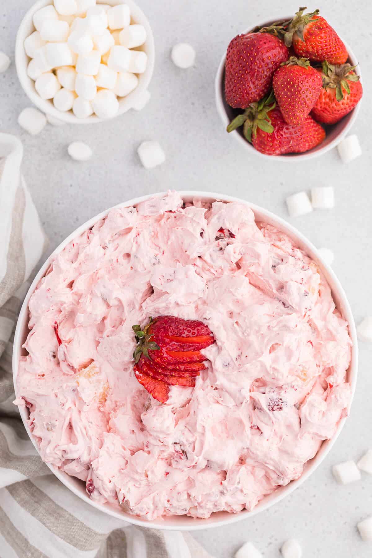 A white bowl of strawberry fluff salad.