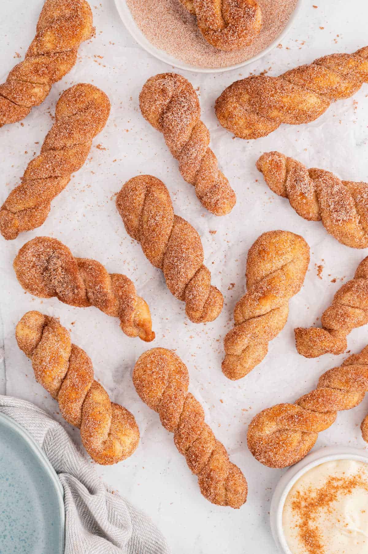 Air fryer cinnamon twists on a white surface.