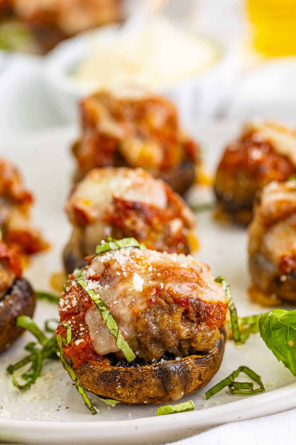 Meatball stuffed mushrooms on a plate.