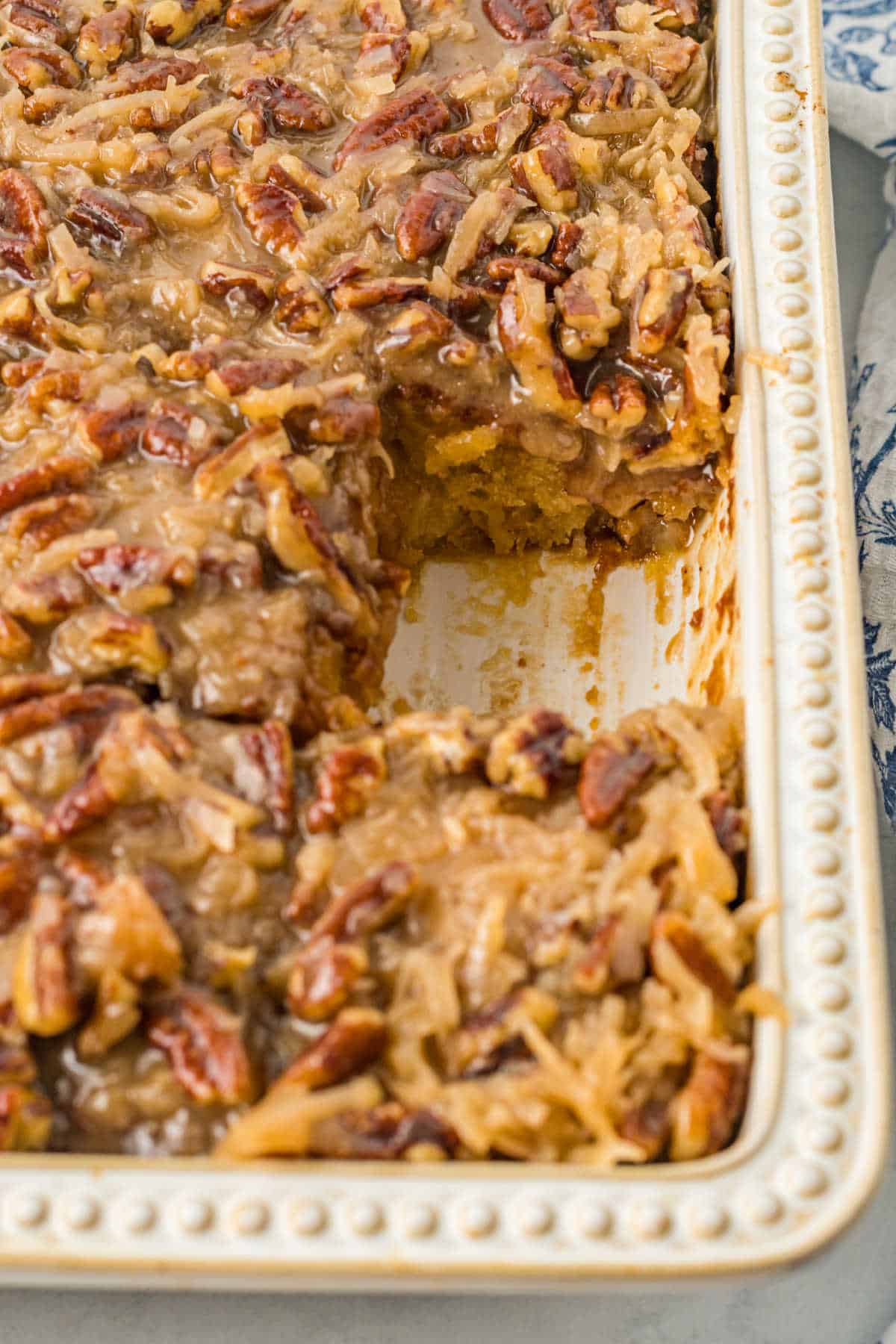 A pan of tornado cake with a piece missing.