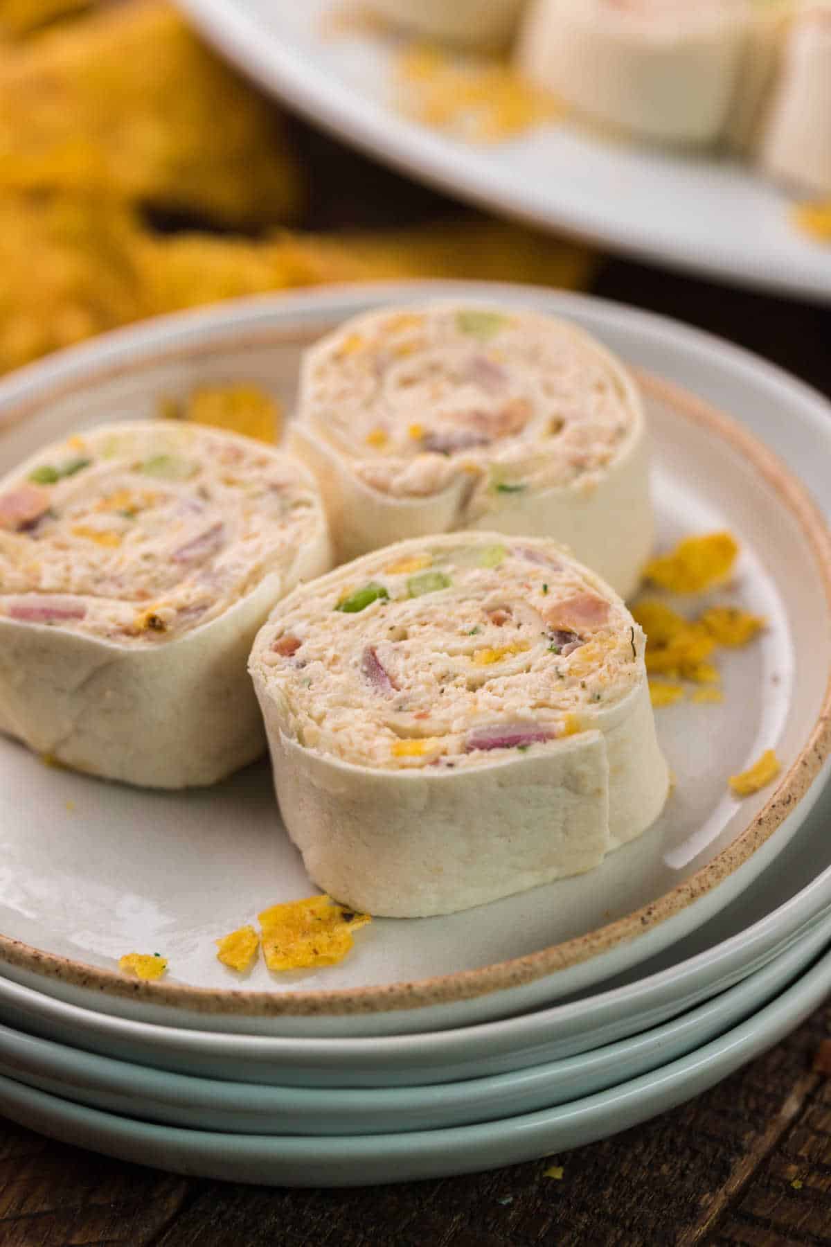 Three chicken pinwheels on a plate.