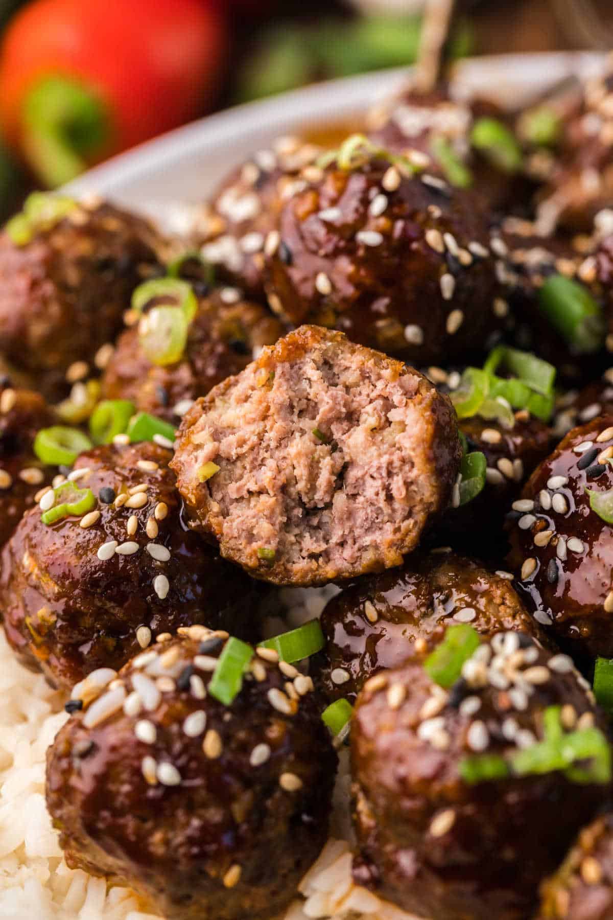 A pile of Korean meatballs with a bite out of one.