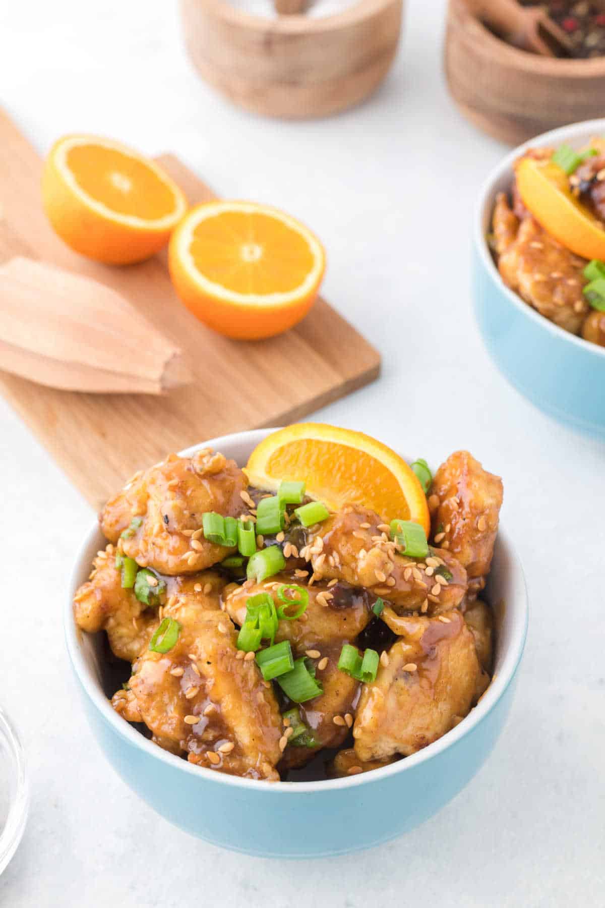 Orange chicken in a blue bowl.