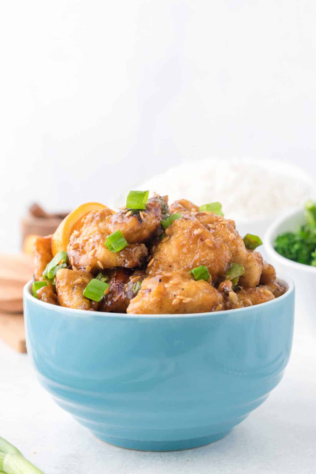 Orange chicken in a blue bowl.