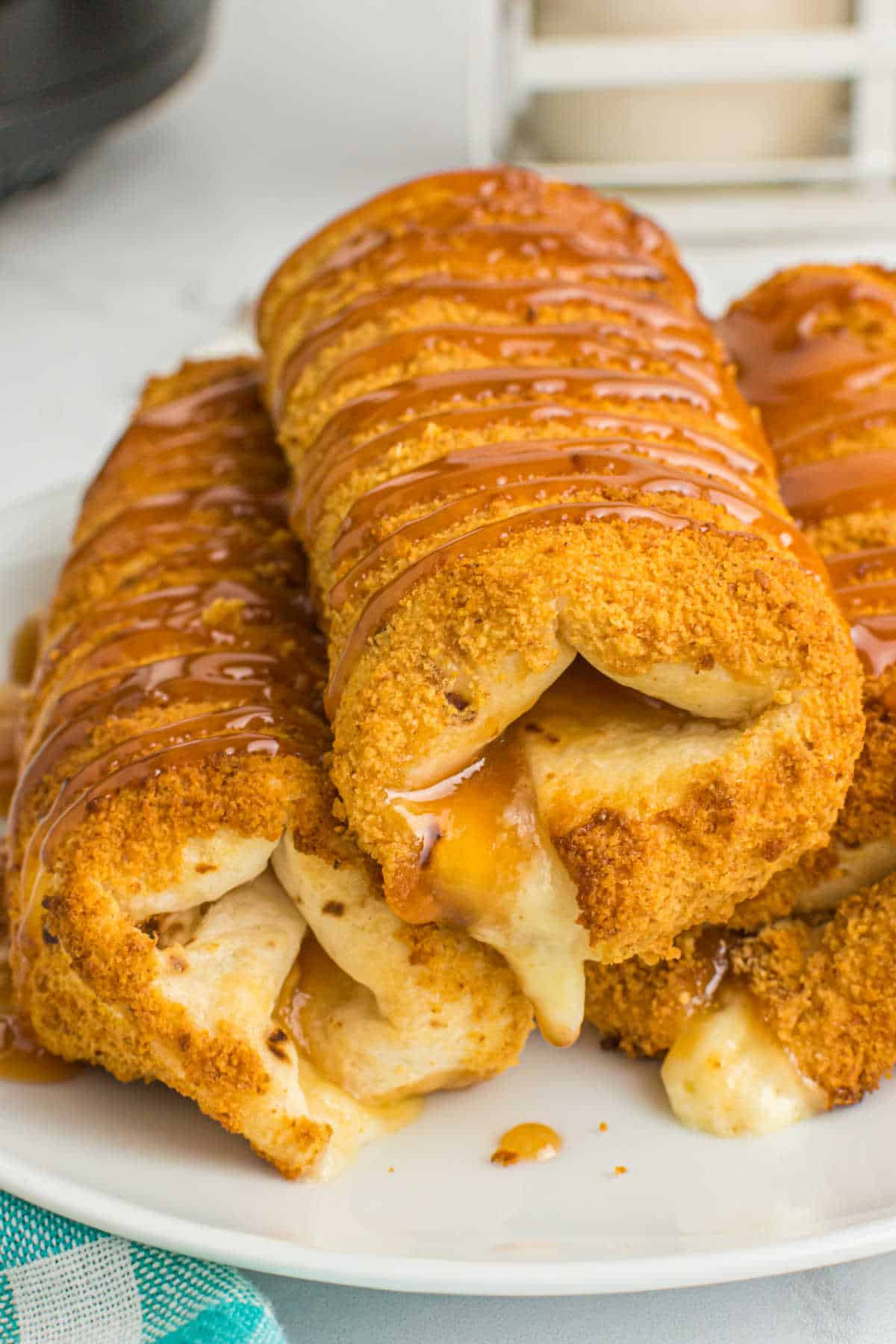 Air fryer chimichangas stacked on a plate.