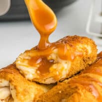 Caramel sauce being drizzled on the recipe with a spoon.