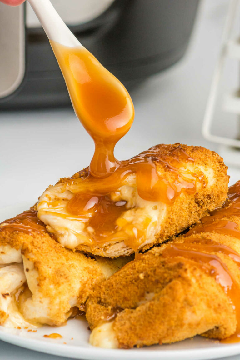 Caramel sauce being drizzled on the recipe with a spoon.