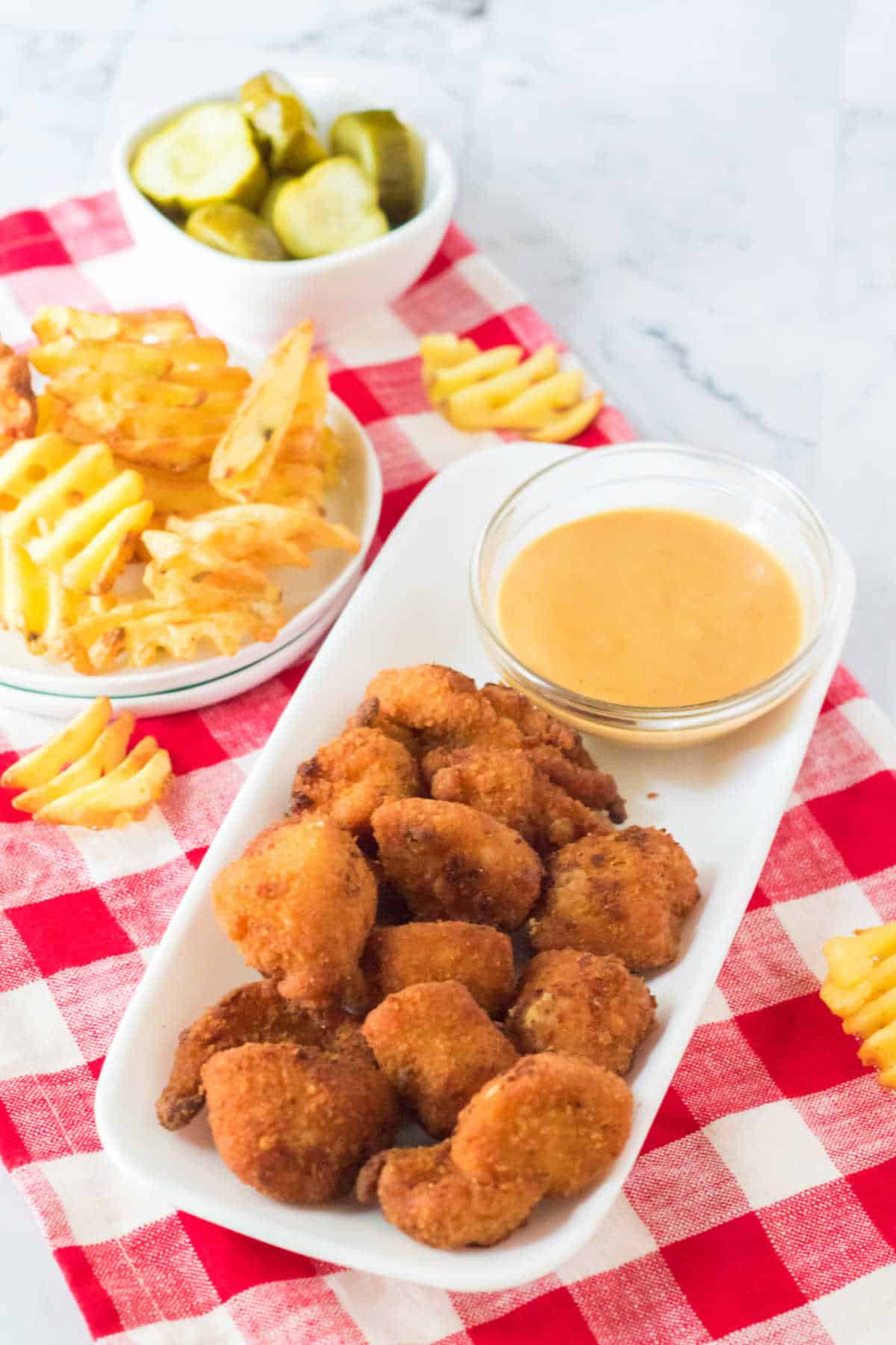Chick Fil A Nuggets with sauce on a platter.