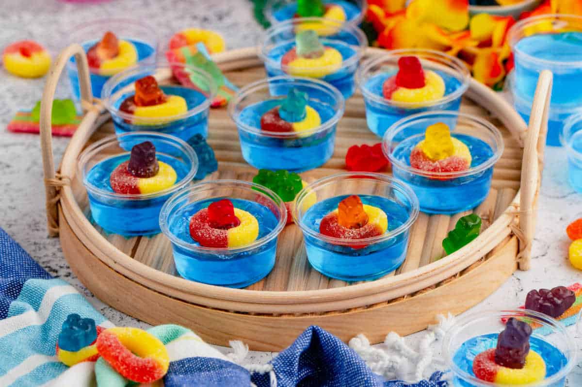 Pool party jello shots on a wooden serving tray.