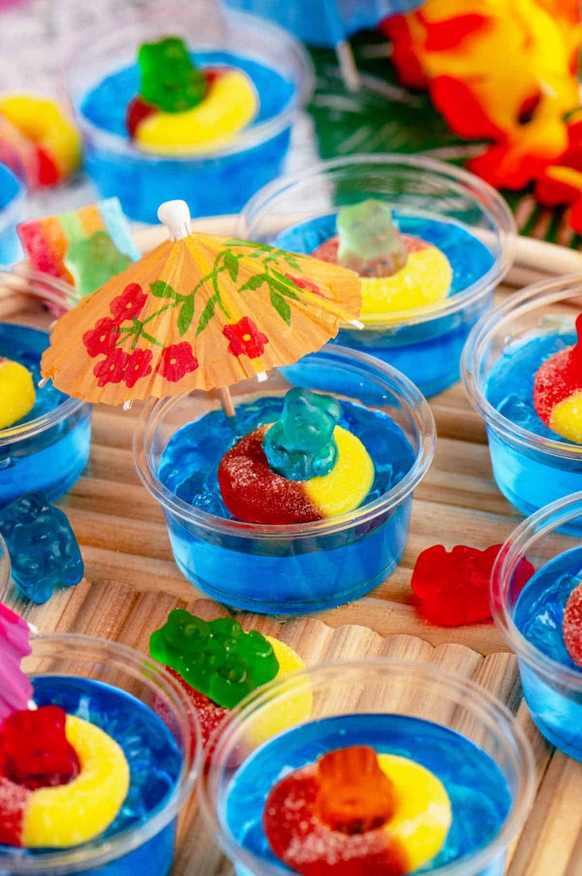 Pool party jello shots on a wooden serving tray.