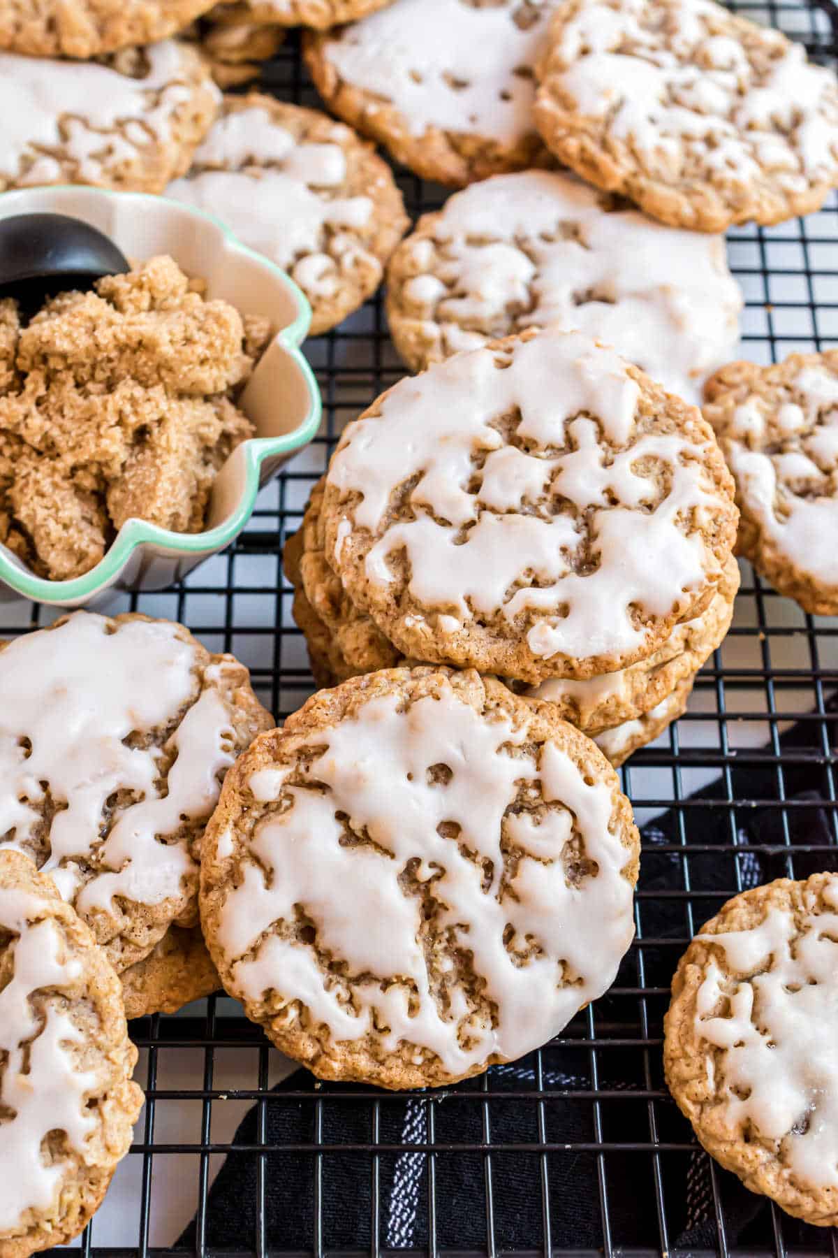 Iced oatmeal cookies on a cooling rack.