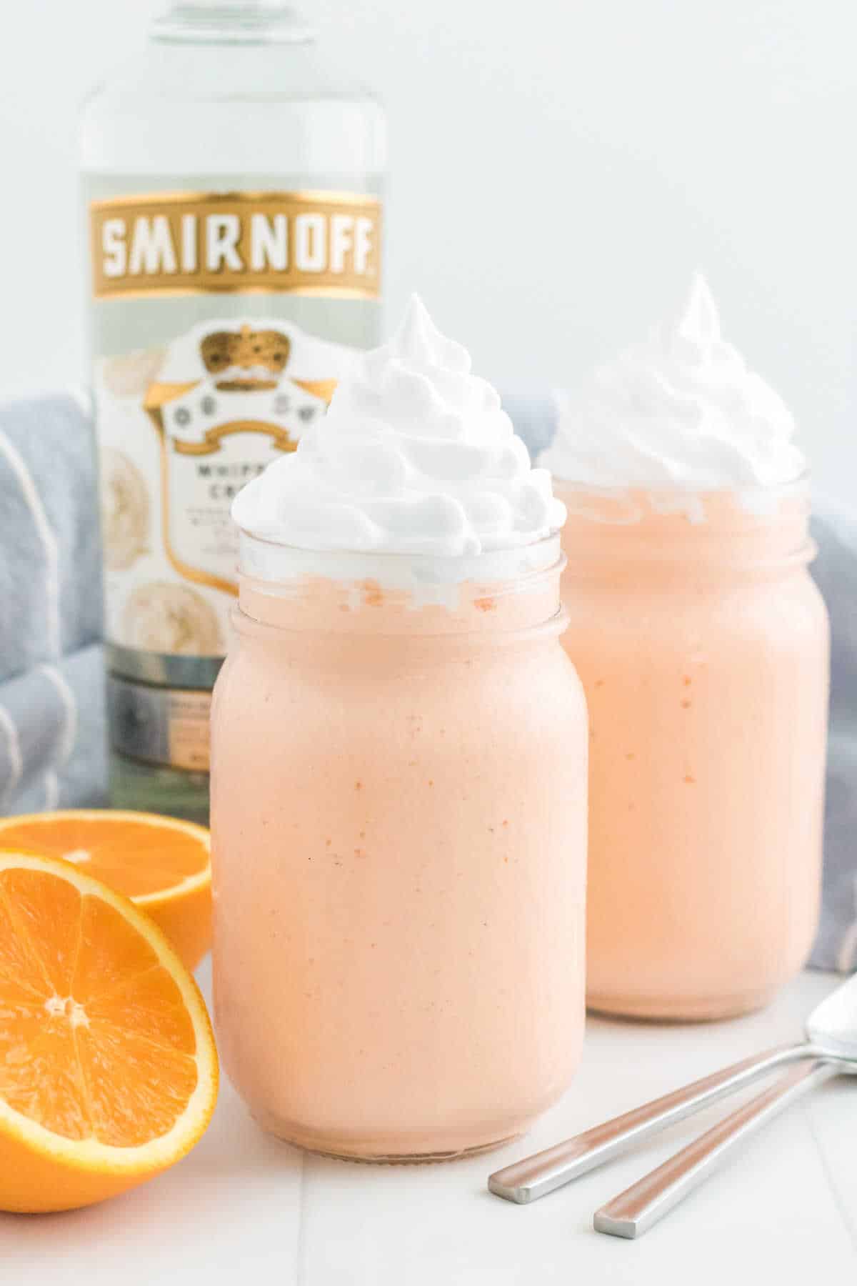 Two boozy orange creamsicle milkshakes. 