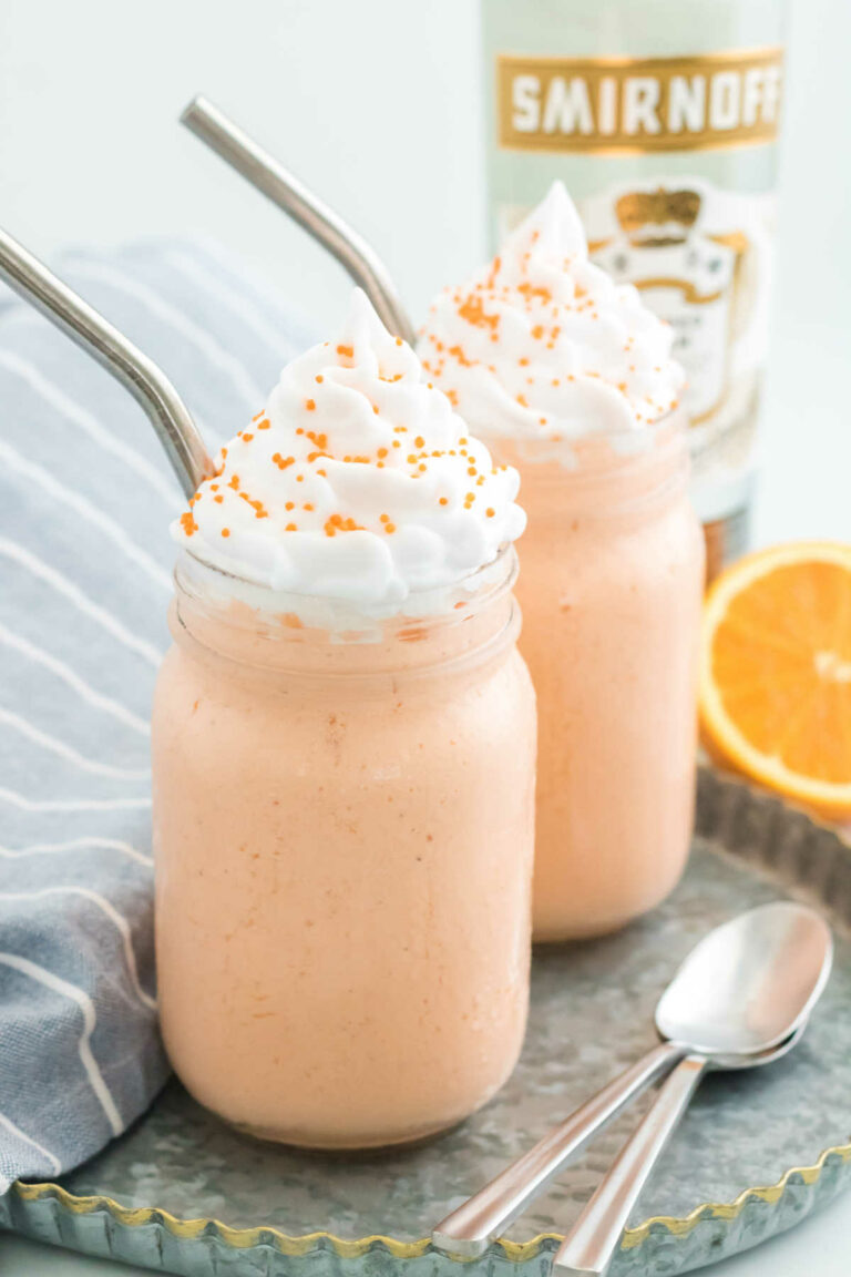 Two milkshakes with metal straws.