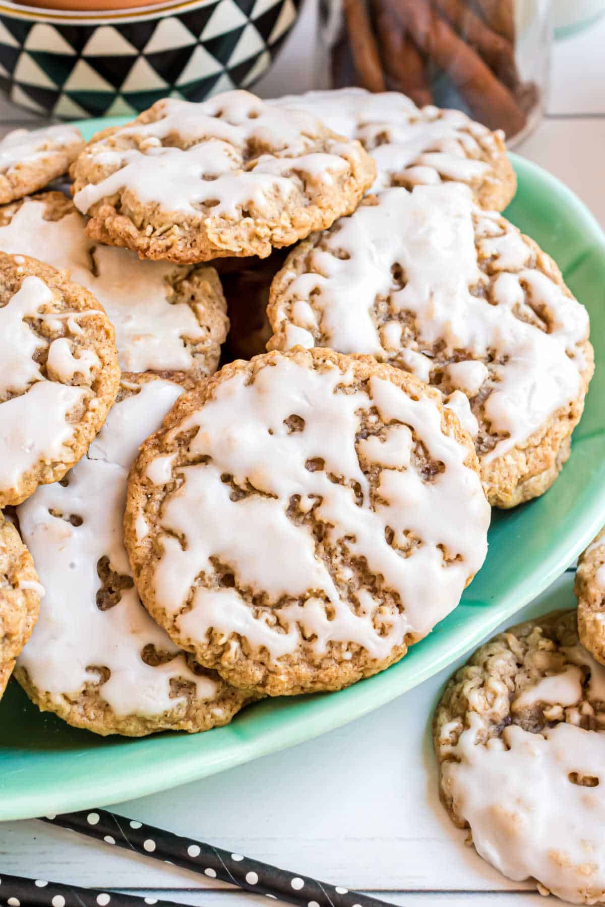 A green plate of iced oatmeal cookies.