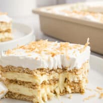 A slice of cake on a plate with a bite out of it.