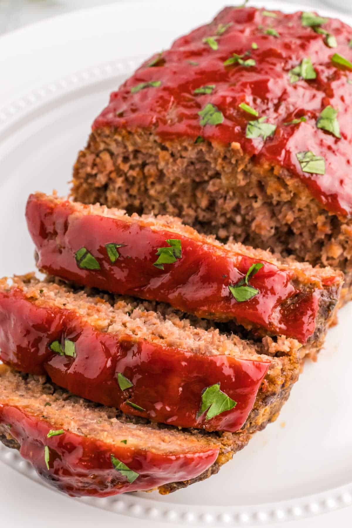 Meatloaf with slices cut on the end on a platter.