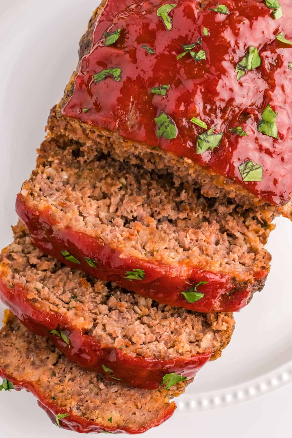 Meatloaf with slices cut on the end on a platter.