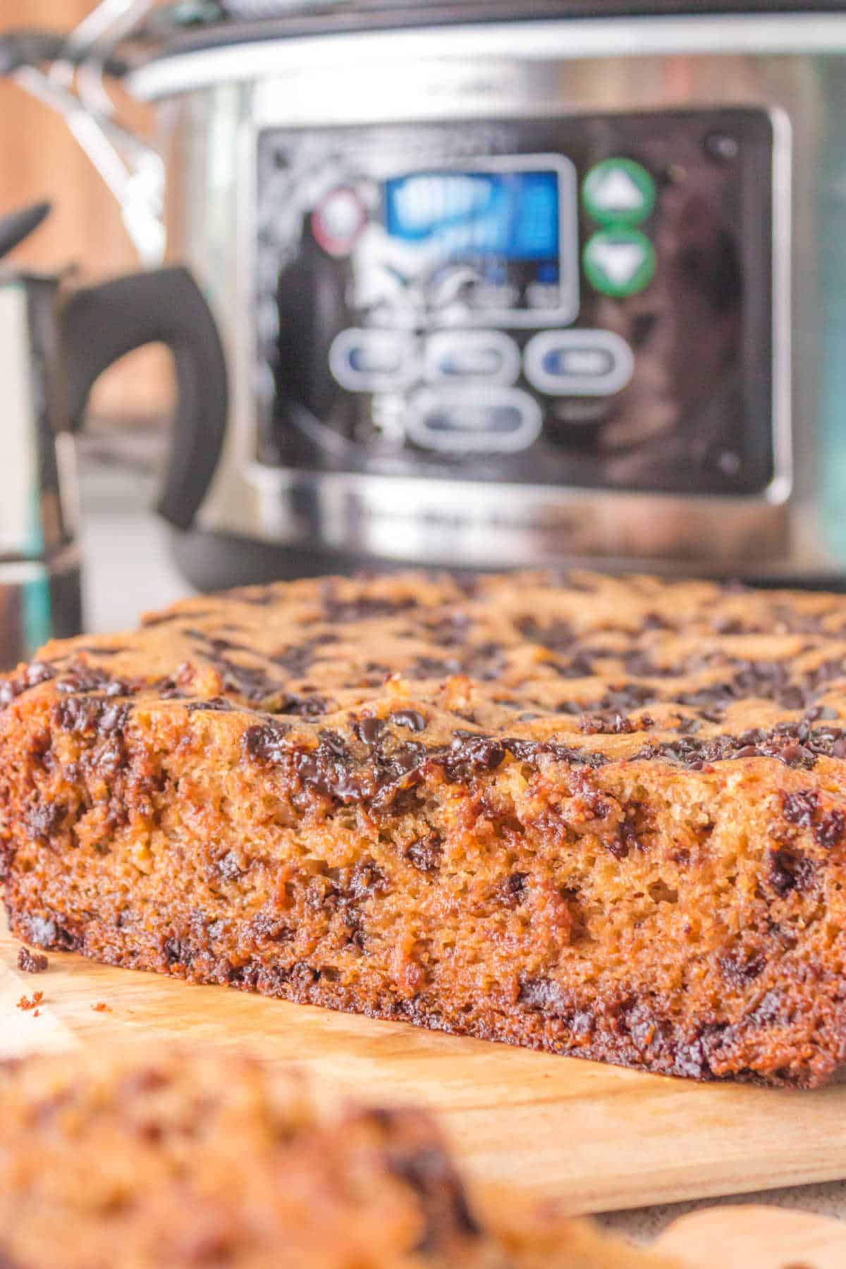 Crockpot banana bread on a wooden cutting board.