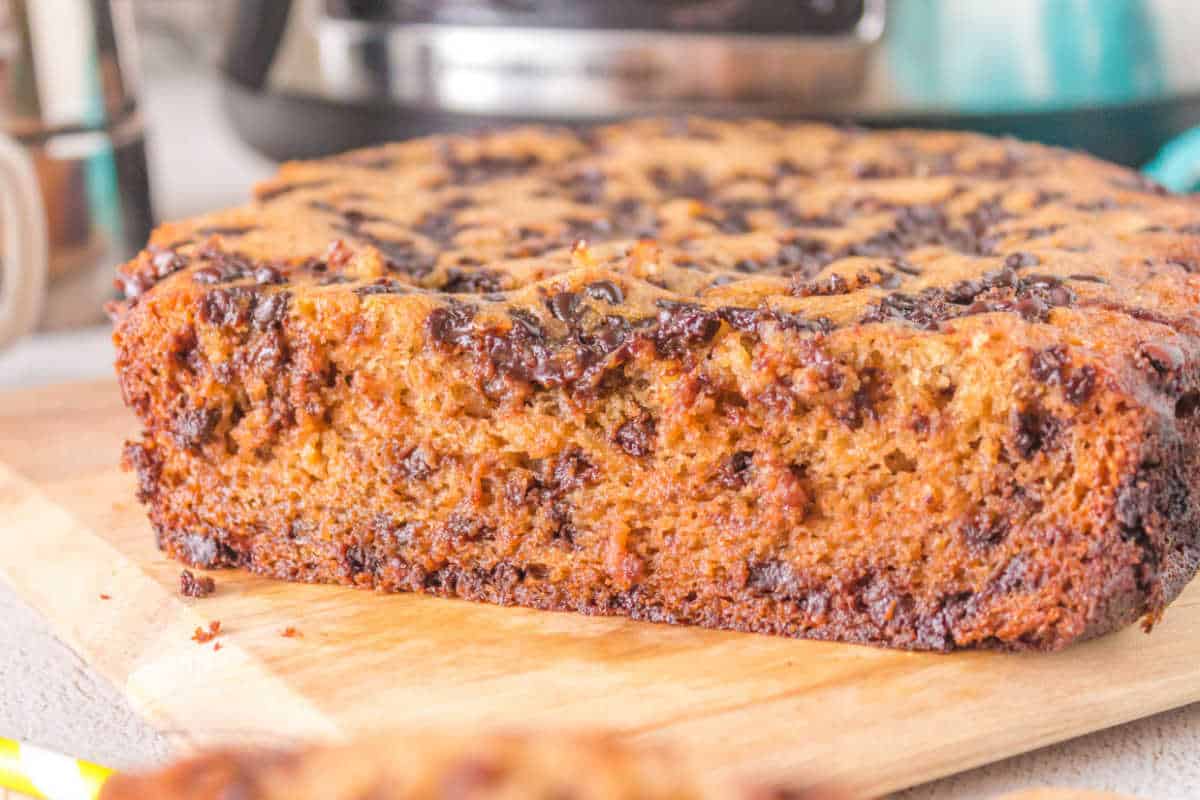 Crockpot banana bread on a wooden cutting board.