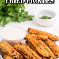 Air fryer pickles on a plate with ranch dressing.