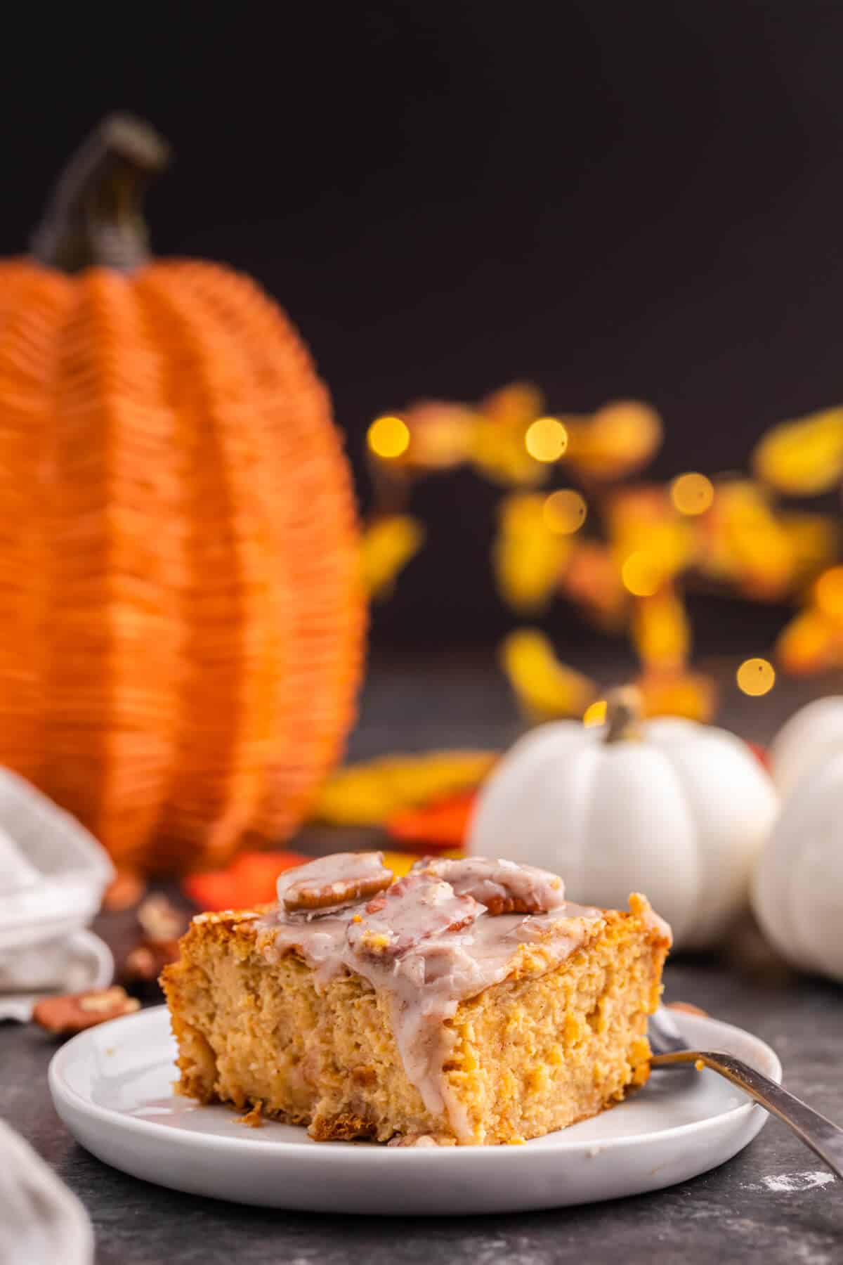 A piece of pumpkin cream cheese danish bake on a plate.