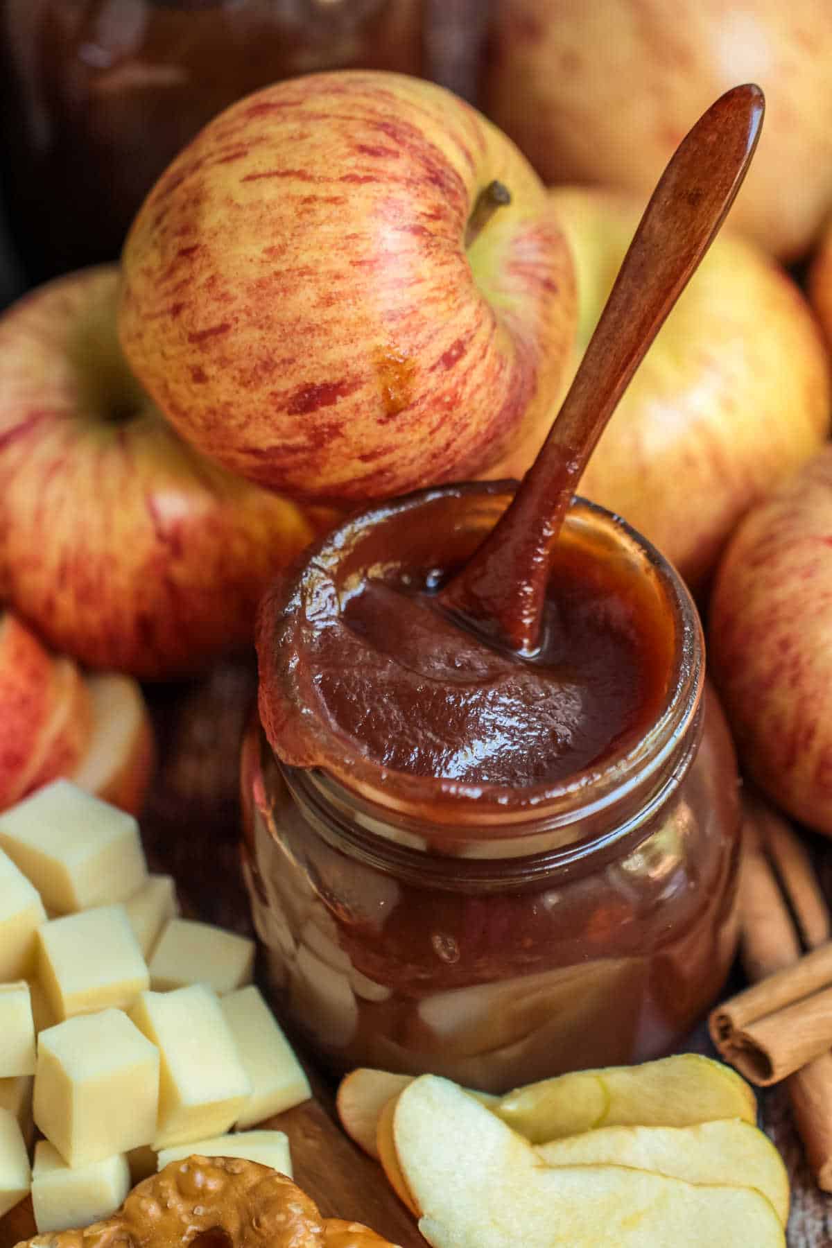 A jar of apple butter with a spoon.