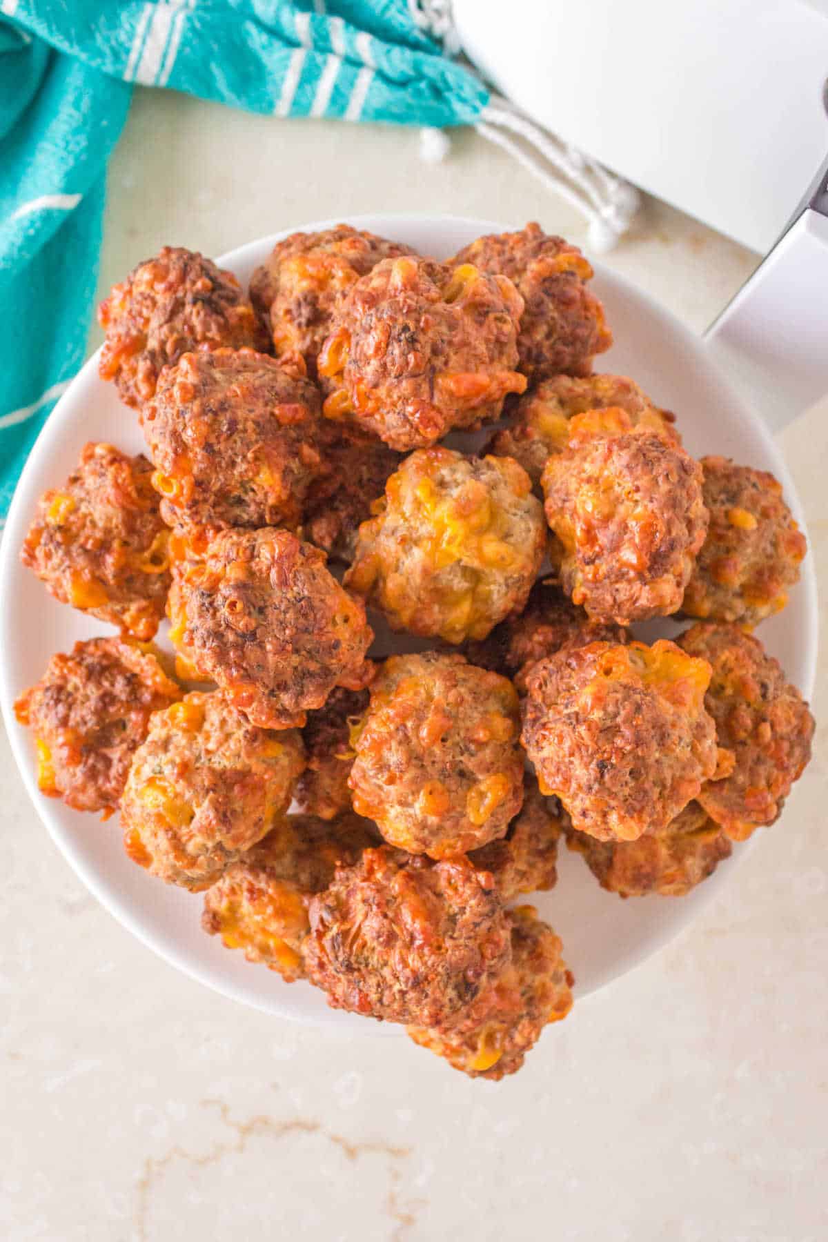 Air fryer bisquick sausage balls on a plate.