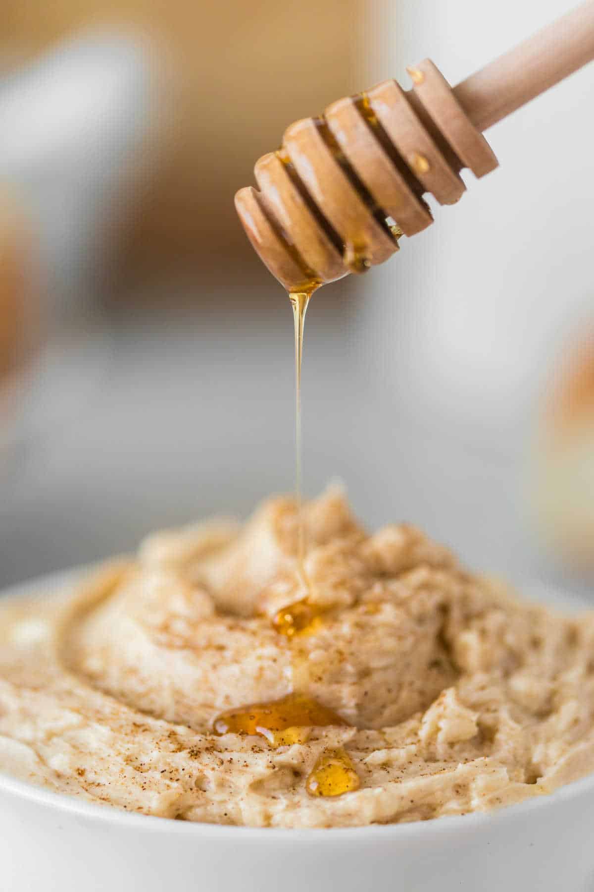 Honey being drizzled over a bowl of cinnamon butter.