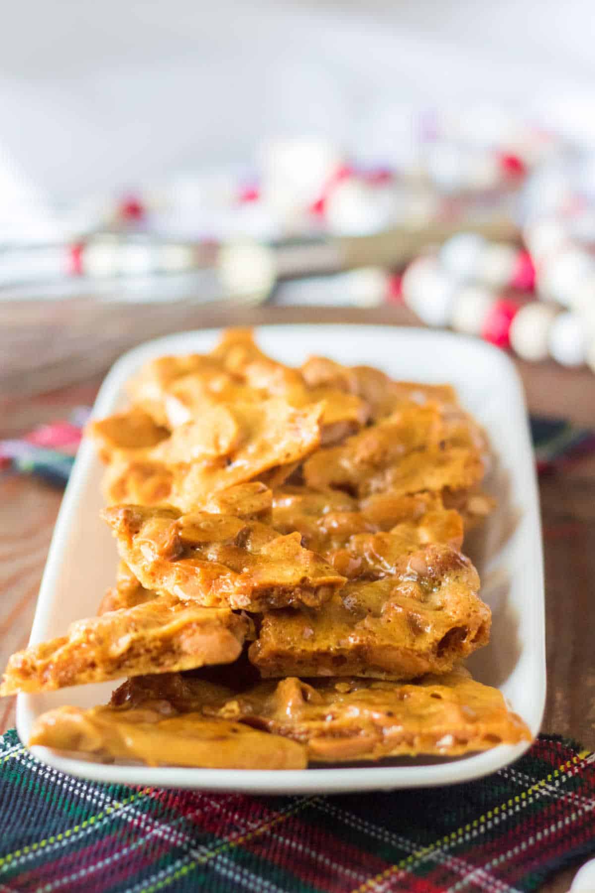 Microwave peanut brittle on a white platter.