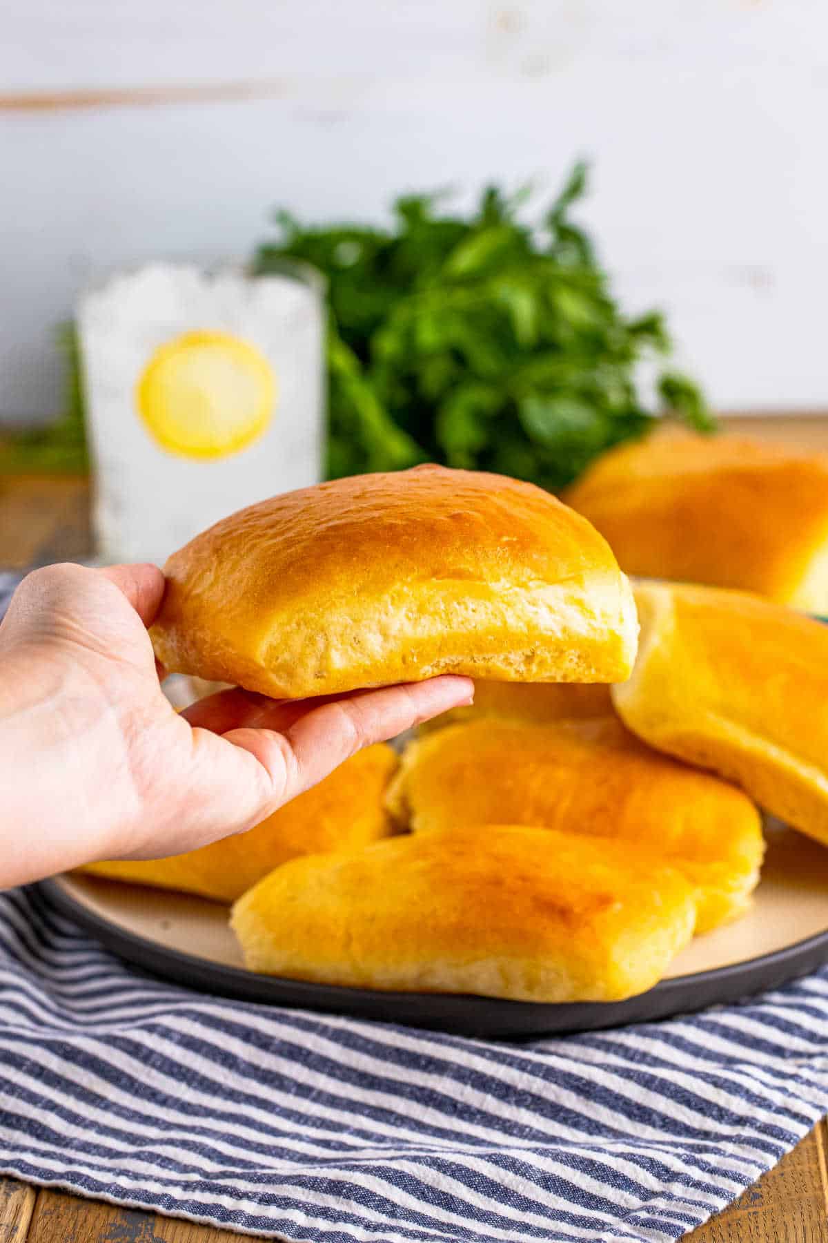 A hand holding a Texas Roadhouse roll.