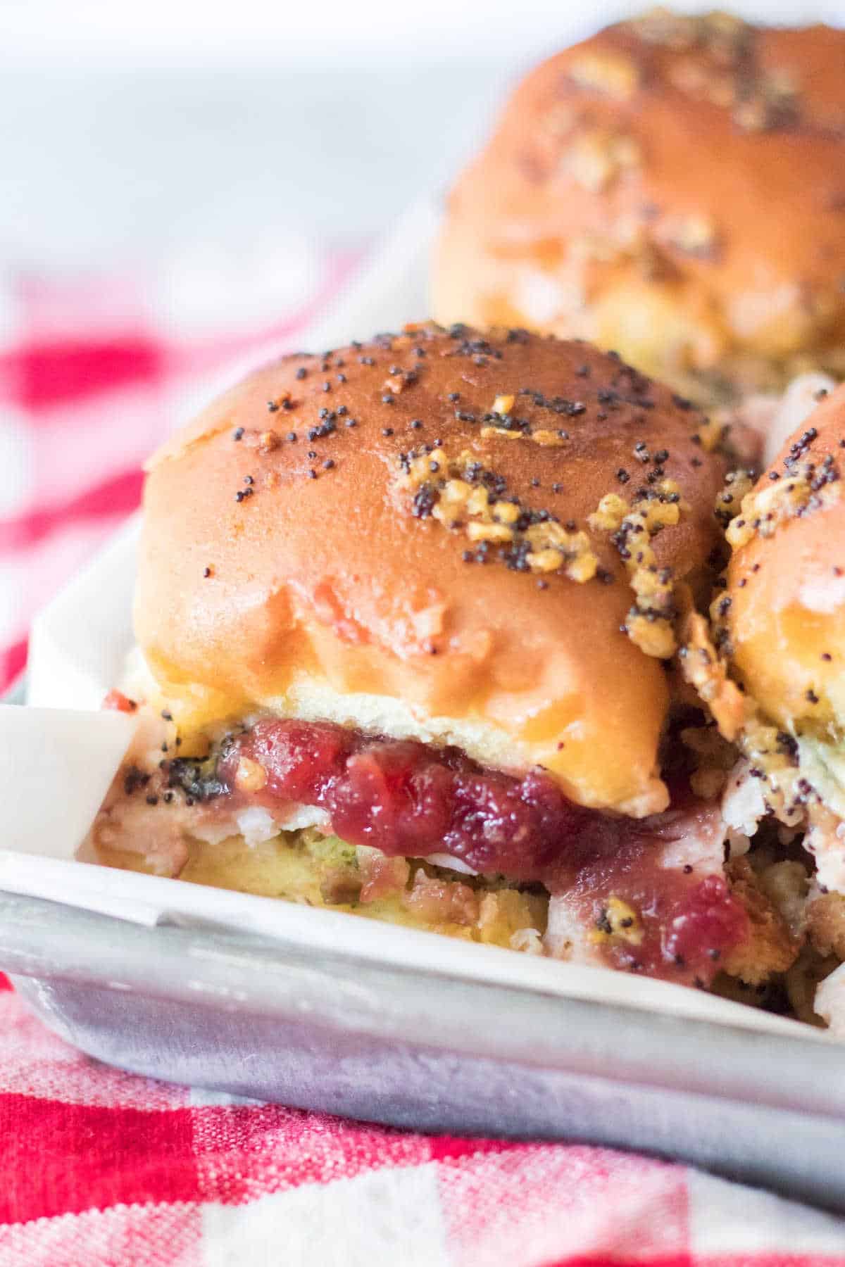 Thanksgiving sliders on a baking sheet.