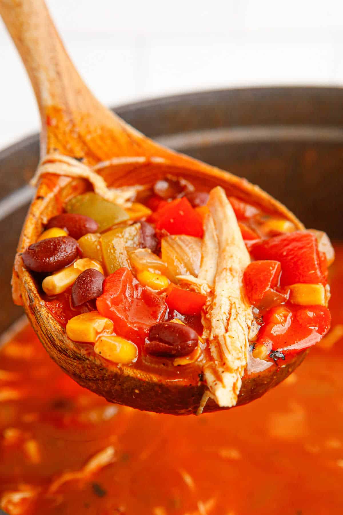 Chicken fajita soup in a ladle.