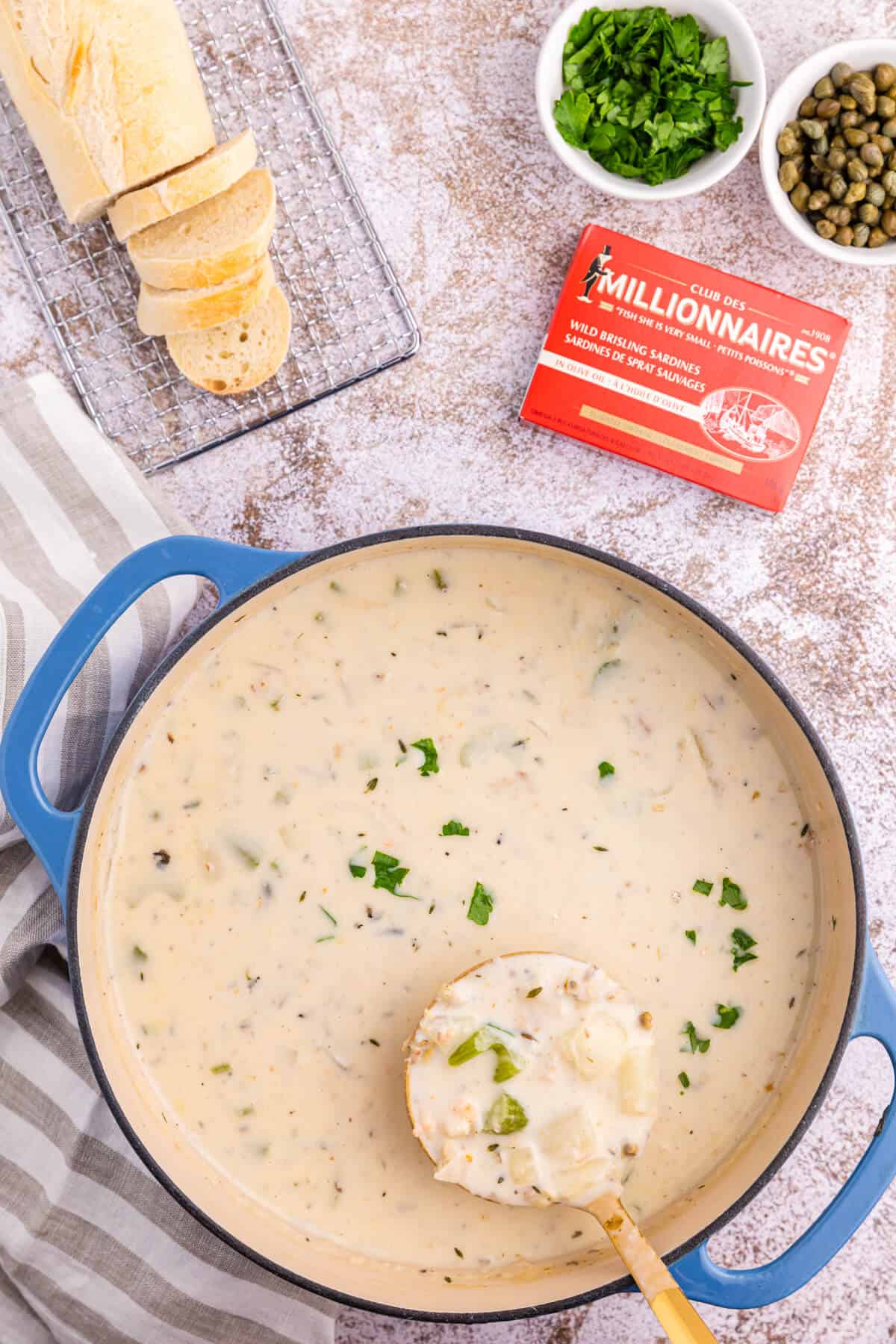 A pot of seafood chowder with a ladle.