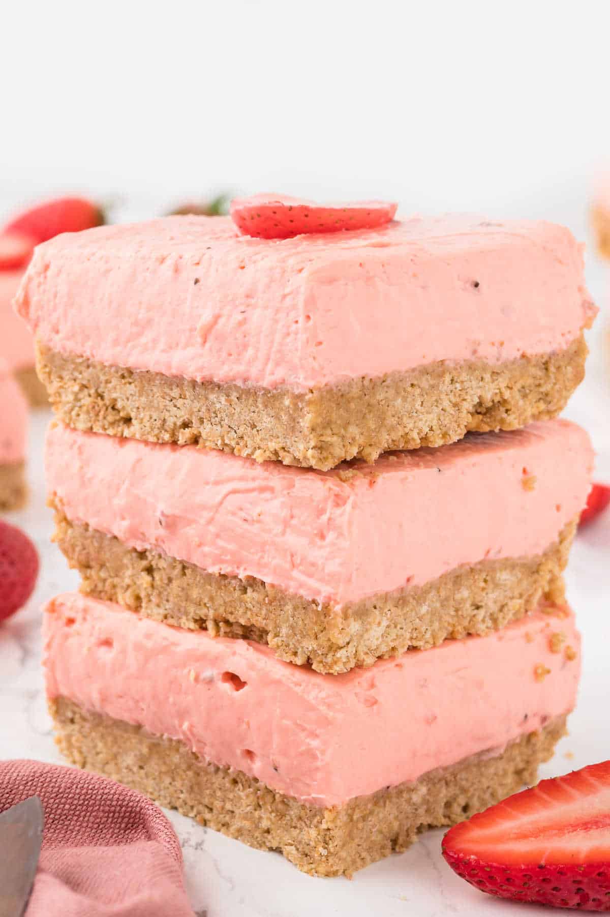 A stack of strawberry cheesecake bars.