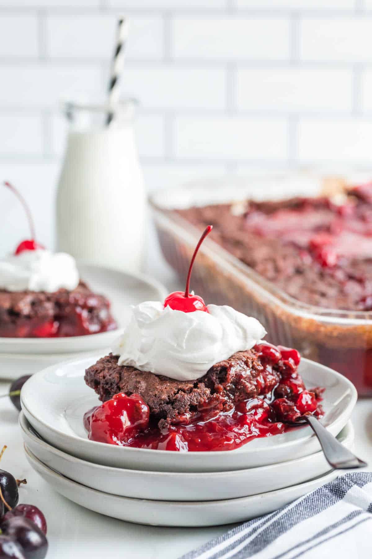 A slice of black forest dump cake on a plate.