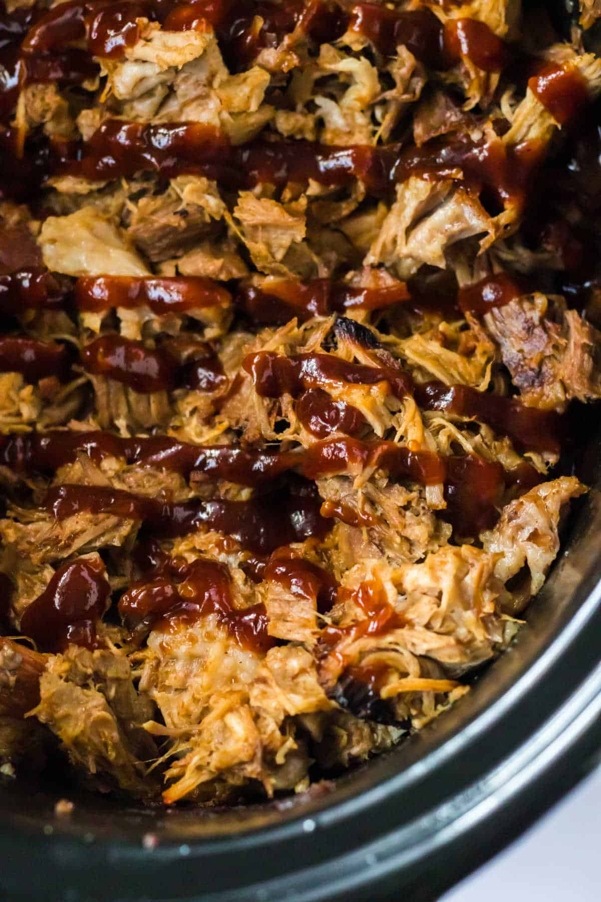 Close up of root beer pulled pork in a slow cooker.