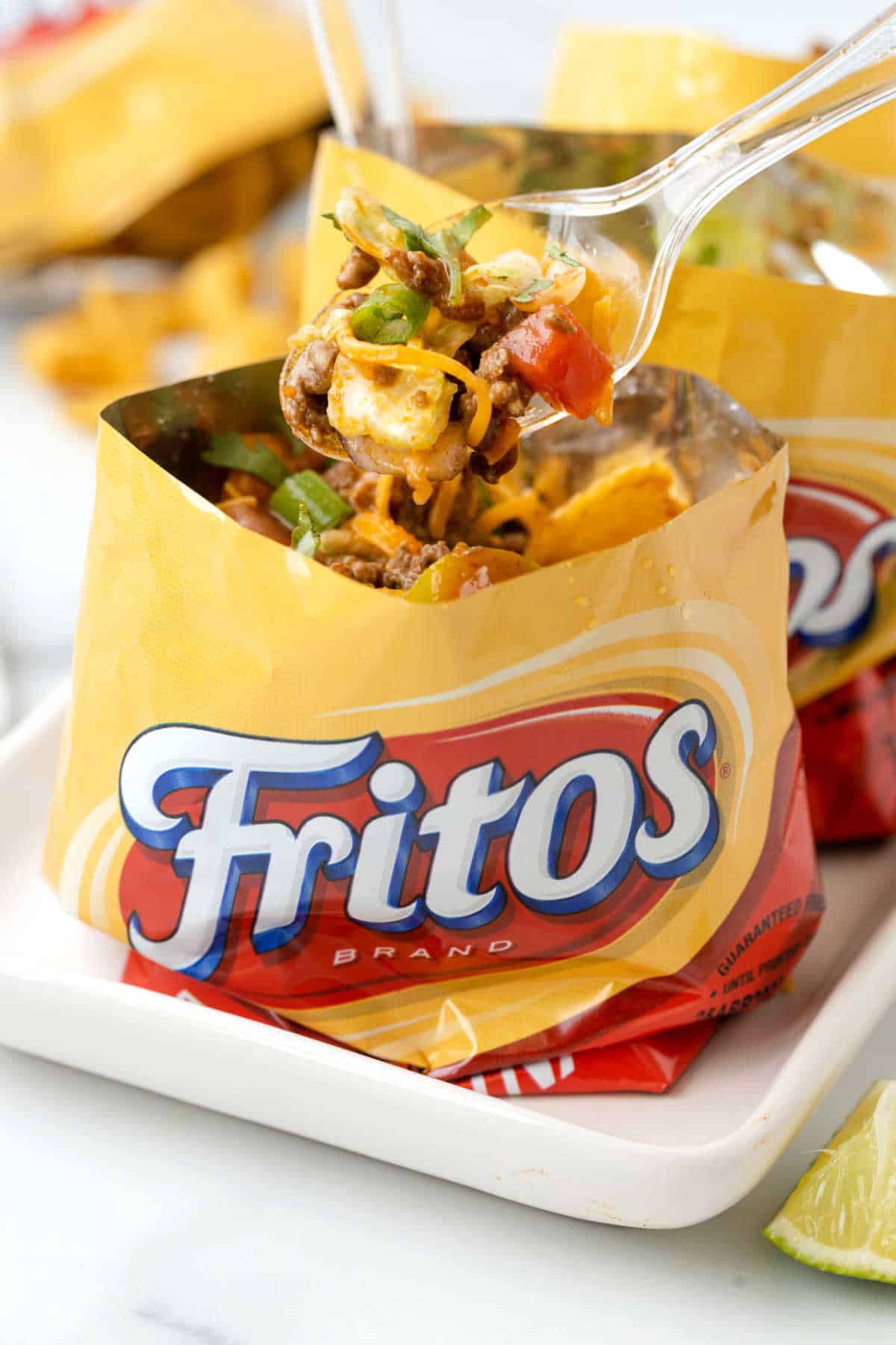 A spoon over a bag of walking tacos.