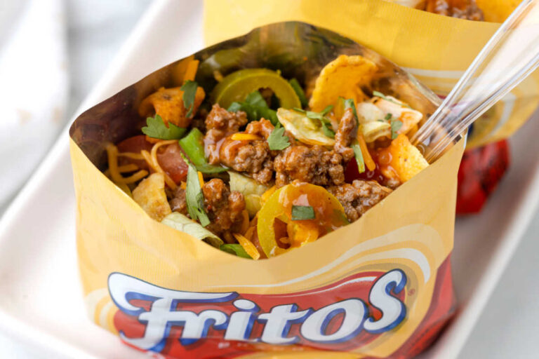 A bag of the recipe on a platter with a spoon inside it.