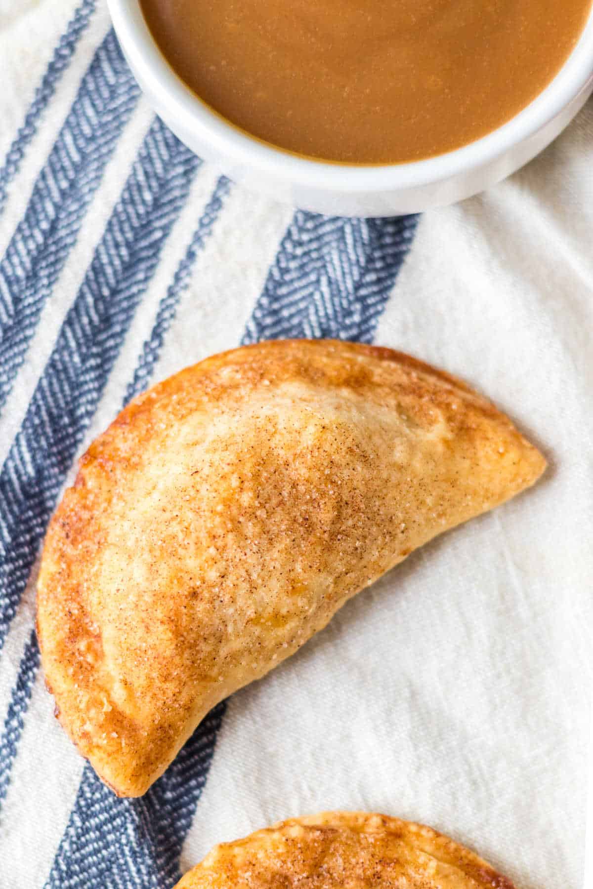 Caramel apple empanadas on a linen.