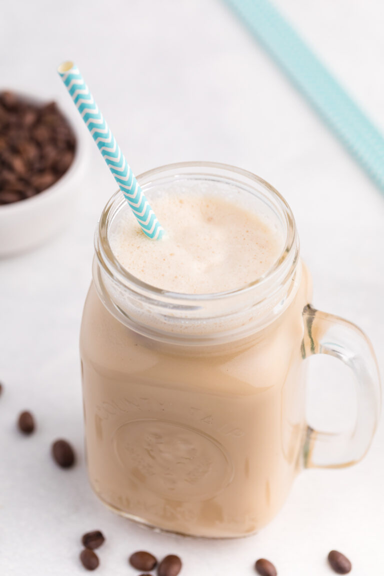 Iced coffee in a jar with a straw.