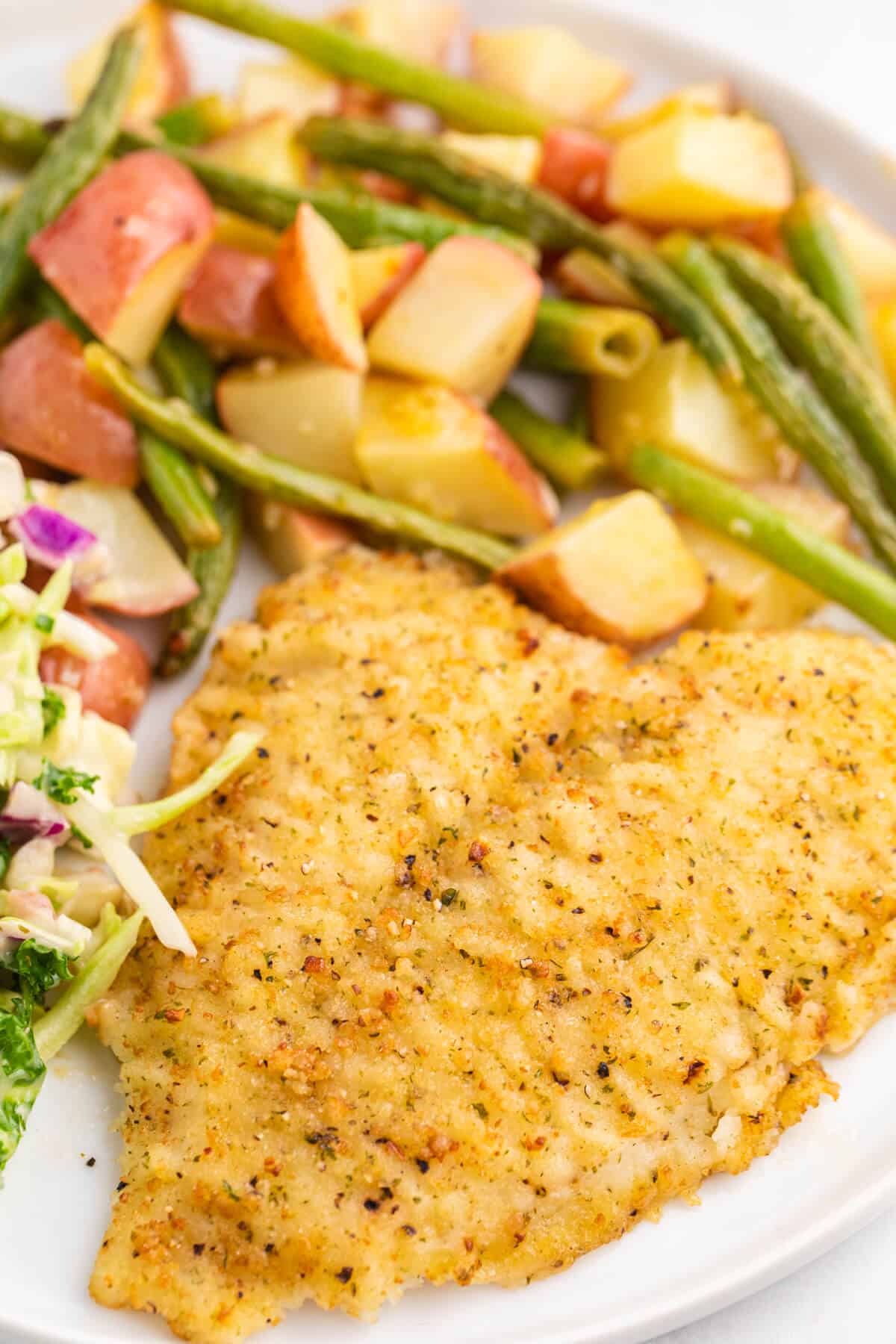 A plate with lemon pepper sole and veggies.