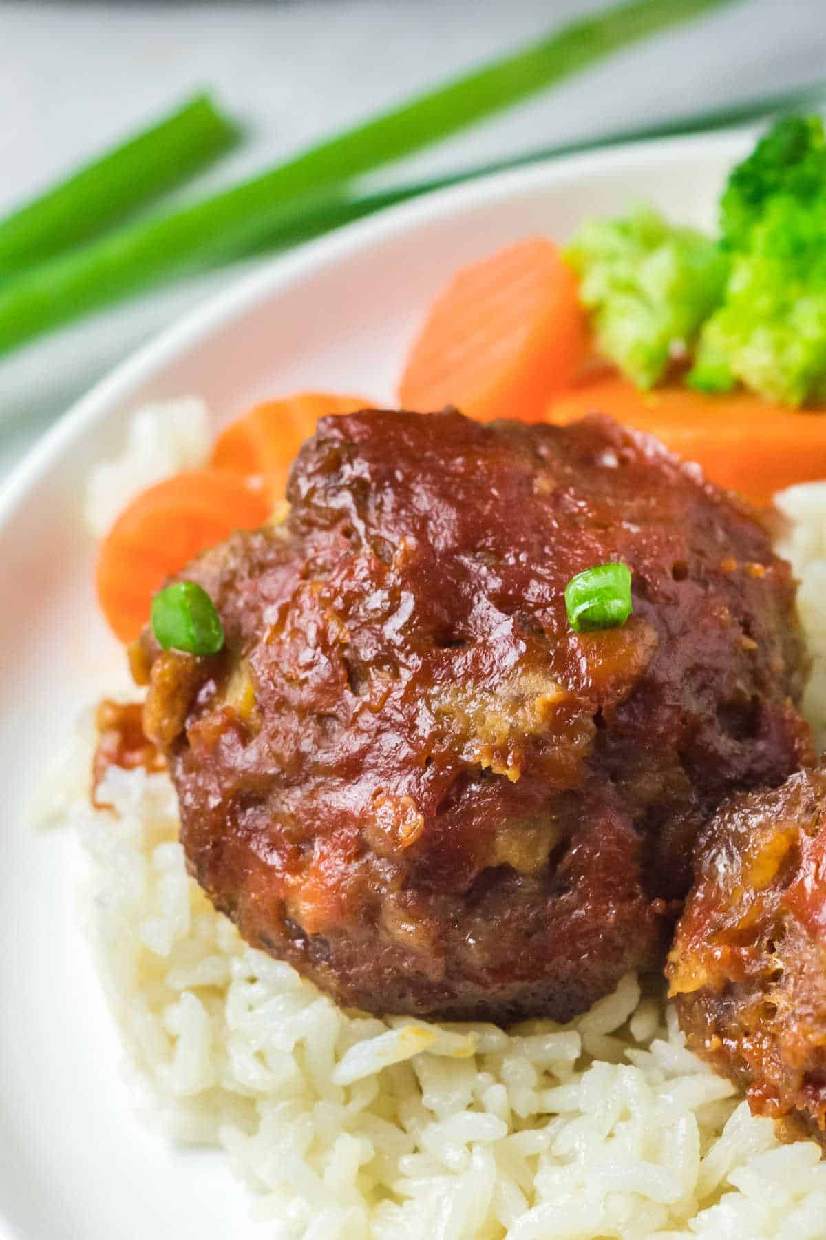 Pineapple ham balls on a bed of rice.