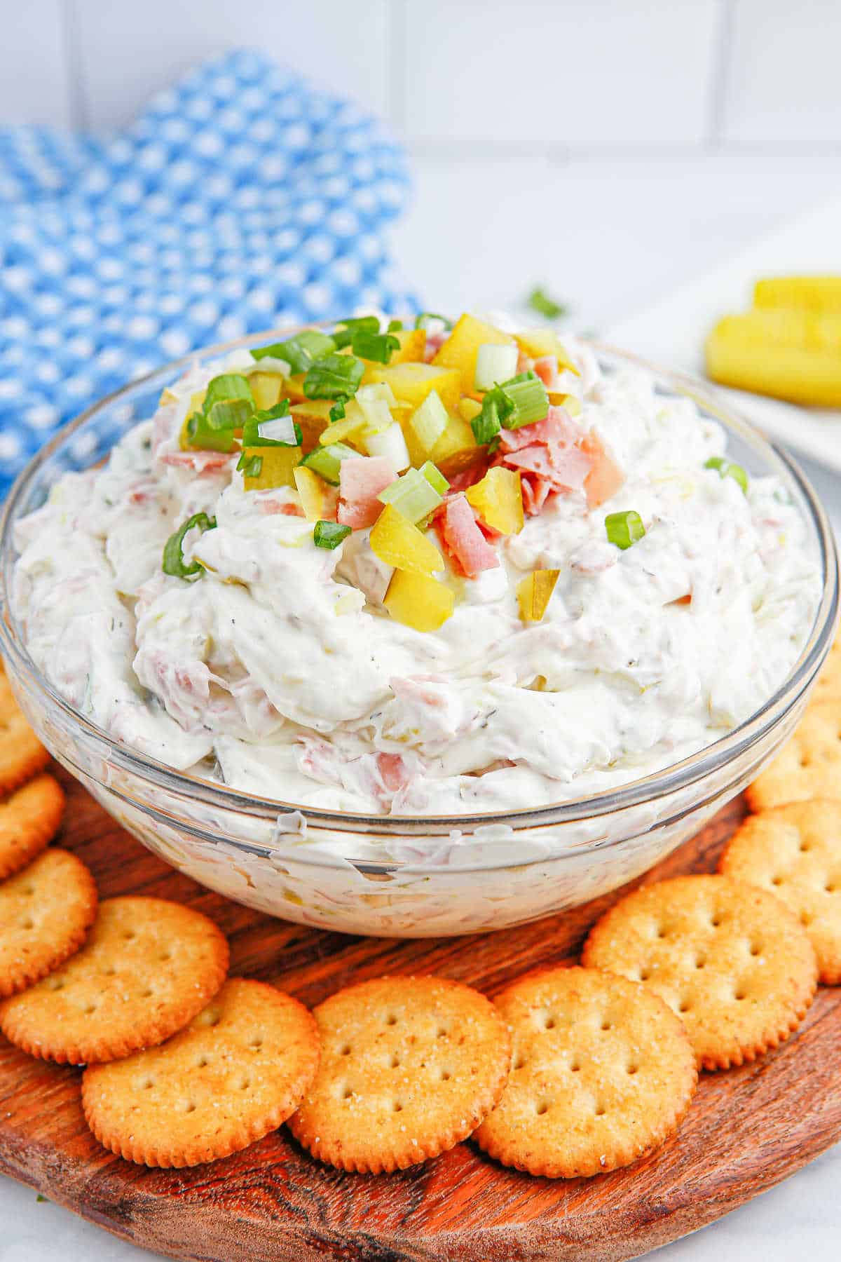 A bowl of dill pickle dip with crackers.