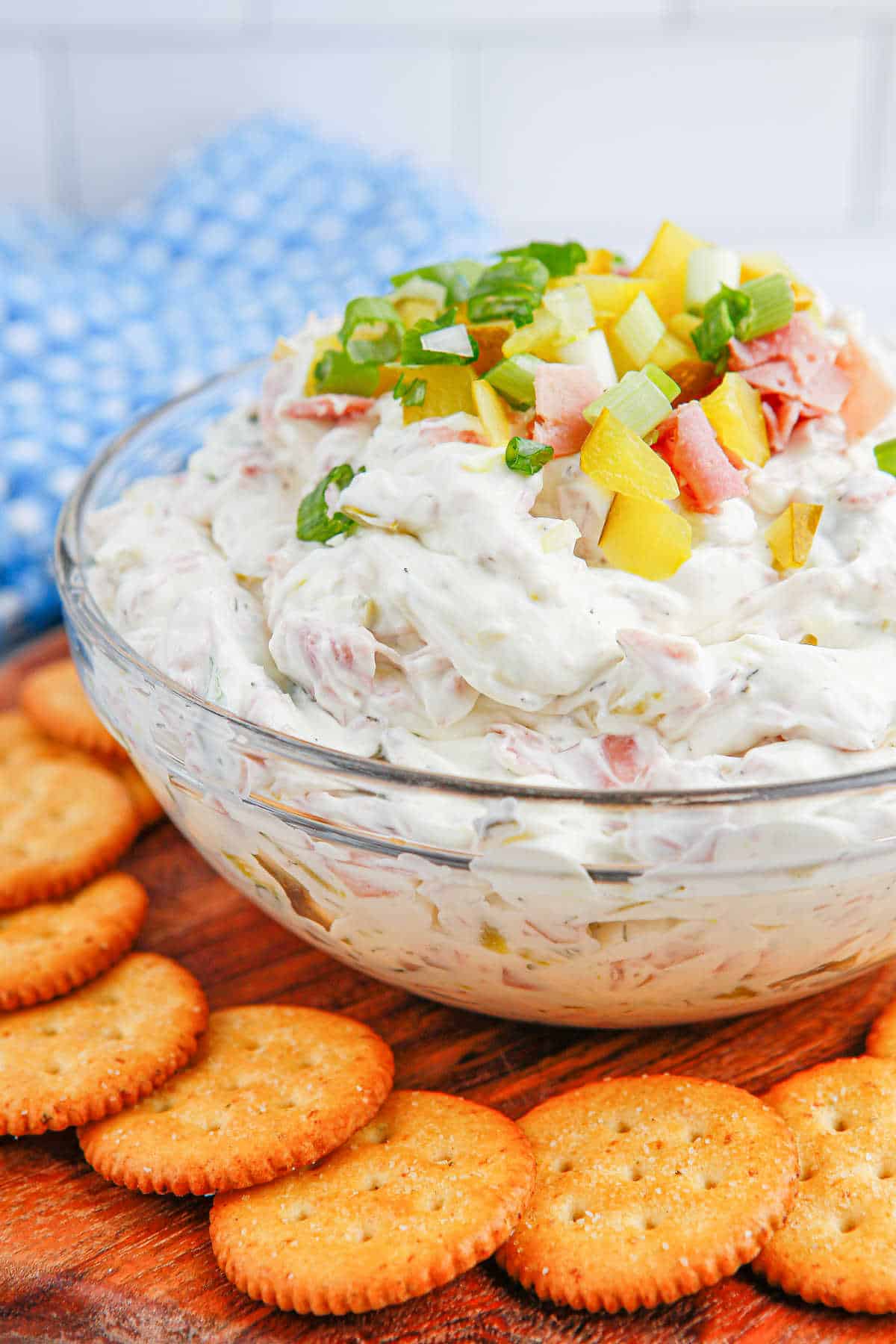 A bowl of dill pickle dip with crackers.