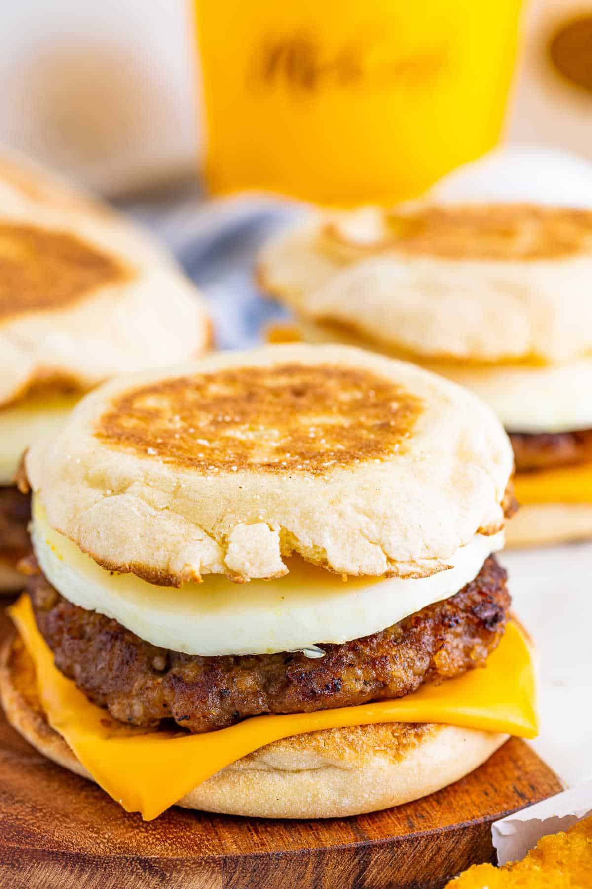 A copycat McDonad's Sausage Egg McMuffins on a wooden surface.